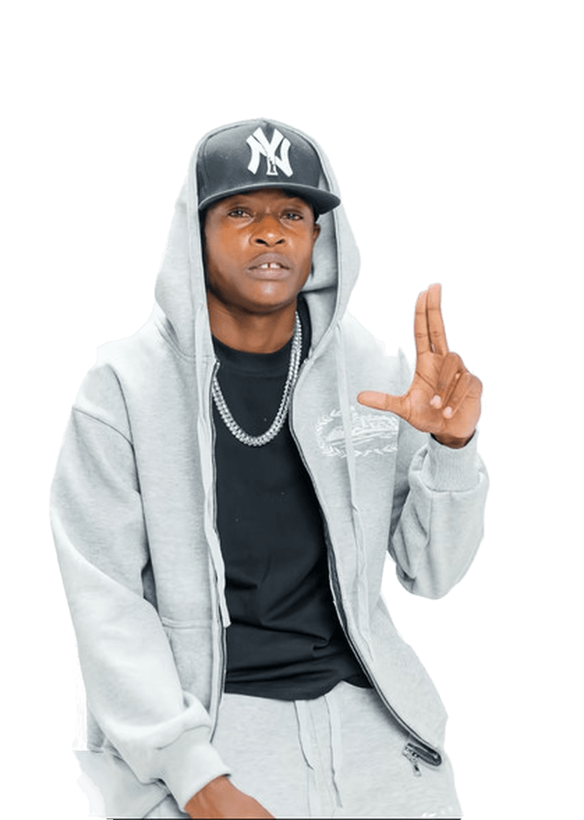 Jnr Spragga in a grey hoodie and black NY cap, one hand raised
